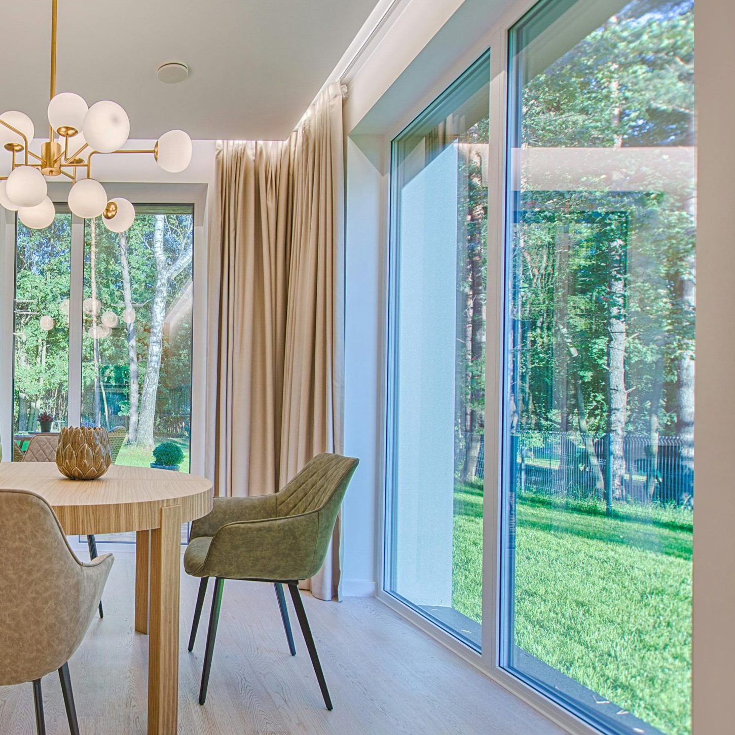 Elegant dining room featuring modern furniture and large windows for natural light.